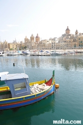 Senglea harbour with a luzzu and the Marine Museum of Victoriosa in the background Senglea harbour with a luzzu and the Marine Museum of Victoriosa in the background