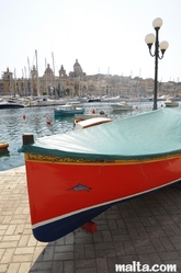 Traditional luzzu boat docked in Senglea Traditional luzzu boat docked in Senglea