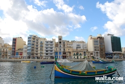 Luzzu and buildings of Spinola Bay