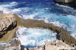 The blue hole near the Azur Window in Dwejra Bay gozo The blue hole near the Azur Window in Dwejra Bay gozo