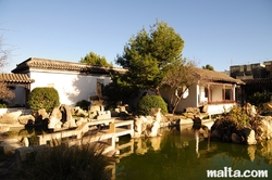 Ornemental Lake and traditionnal constructions in the Garden of Serenity in Santa Lucija