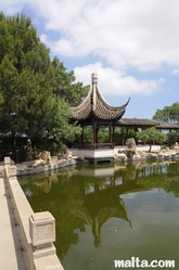 Side small temple and lake of the Garden of Serenity in Santa Lucija