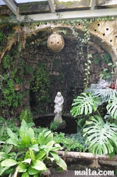 statue in the greenhouse of the palazzo parisio garden