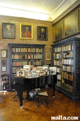 Piano and paintings inside the Library of the Casa Rocca Piccola in valletta