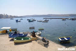 bench and people on the Bugibba's Harbour