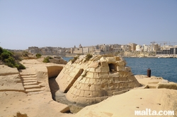 War shelter on the Kalkara's sea shore and valletta in the background
