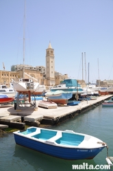 Boat shored in front of the St anne Church of Marsascala