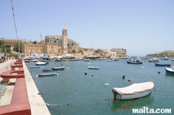 Small Luzzu Marina and St Anne Church in Marsascala