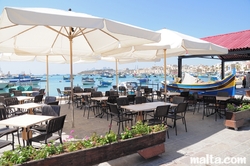 Bar and tables on the Marsaxlokk Bay promenade Bar and tables on the Marsaxlokk Bay promenade