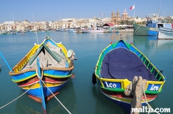 Luzzu and the Parish church in Marsaxlokk