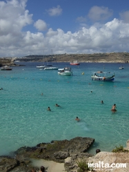 Blue lagoon and boats in Comino