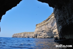 Under the cliff by boat