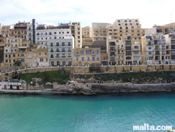 xlendi hotel and building above the sea
