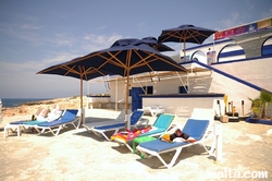 Sun chairs and ombrellas in the Armier Bay
