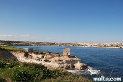Tower in St Thomas bay and Marsaskala in the distance Tower in St Thomas bay and Marsaskala in the distance