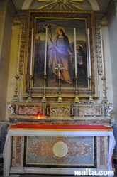 side altar with candle inside the Cittadella Cathedral in Victoria Gozo