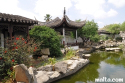 Side temple and lake of the Garden of Serenity in Santa Lucija