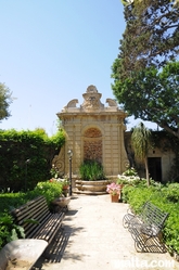 benches and wall of the palazzo parisio garden