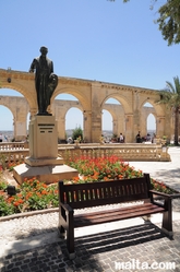 bench in the shade at the fountain and sun in the Upper Barrakka Gardens valletta