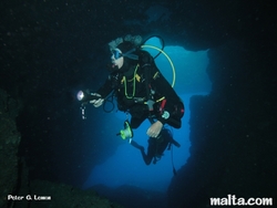 Divers exploring Comino caves