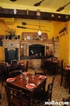 Tables and wood stove inside Ta'Kris Restaurant and Maltese Bistro